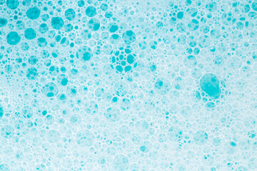 Blue water with foam bubbles.Cleanliness and hygiene background. Foam Water Soap Suds.Texture Foam...