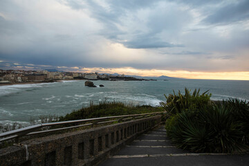 Stairway down to the ocean during a sunset in Biarritz, France 