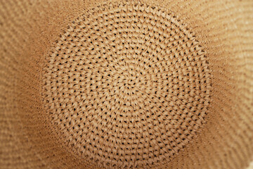 Fototapeta na wymiar craft color natural raffia hat as a textured crochet background