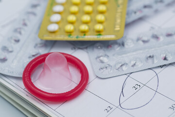 condom with contraceptive, birth control pill, safe sex
