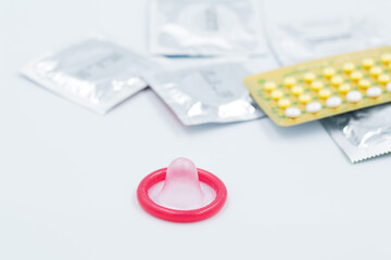 condom with contraceptive, birth control pill, safe sex
