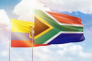 Sunny blue sky and flags of south africa and ecuador