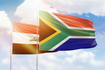 Sunny blue sky and flags of south africa and iraq