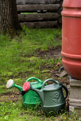 rain barrel and two watering cans