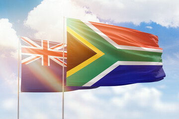 Sunny blue sky and flags of south africa and new zealand