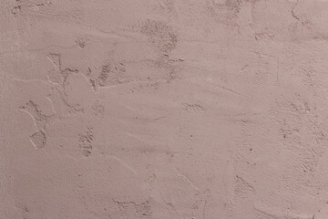 Texture of cracked concrete painted with pink paint with cracks and bumps. Wallpaper, Background. Close-up.