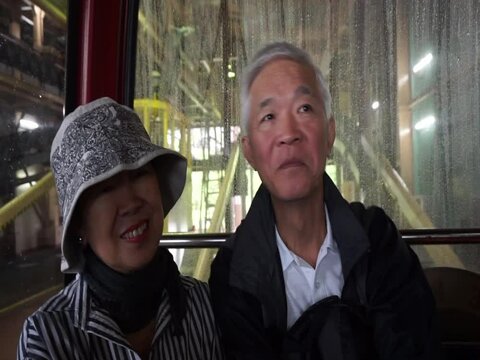 Asian senior couple retirement vacation trip travel on ropeway cable car in Japan