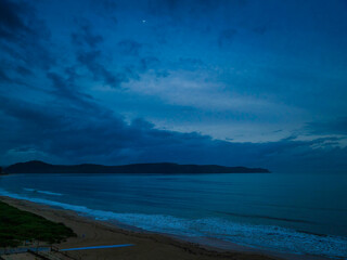 Fototapeta premium Moody aerial sunrise seascape with rain clouds