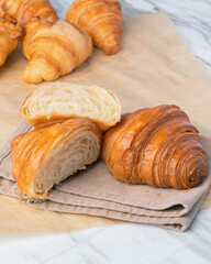 Fresh croissants bread on marble table. French breakfast.