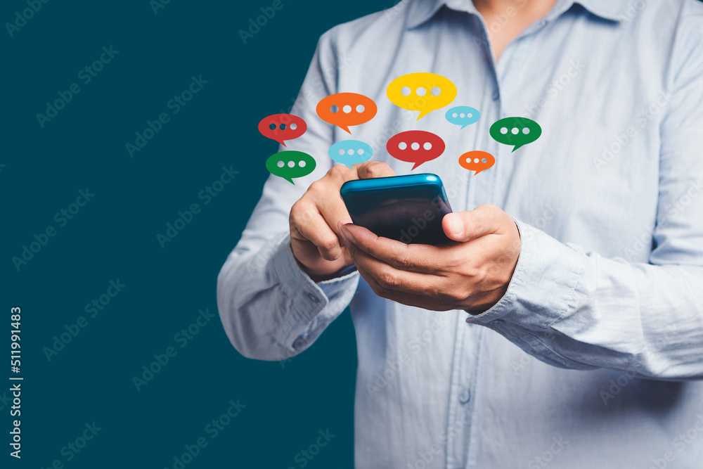 Aufkleber close-up of hands using mobile phone with colorful chat icons on application communication digital w