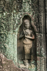 Fototapeta na wymiar A sandstone carving depicting Apsara styling her hair at Ta Som Temple in Siem Reap Angkor Wat, Cambodia.