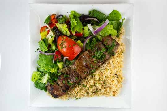 Beef Kebab with rice and salad.