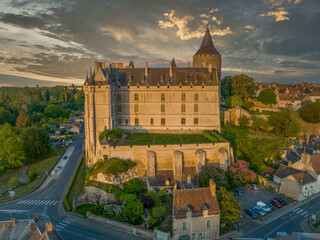 Fototapeta premium Sunset aerial view of Chateaudun castle in Eure-et-Loire in France with imposing circular keep, Gothic high chapel, Renaissance residential palace and bell tower perched on a limestone outcrop