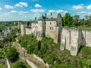 Fototapeta na wymiar Aerial view of the royal lodgings in the middle castle of Chinon with adjoining curtain walls restored recently with blue cloudy summer sky