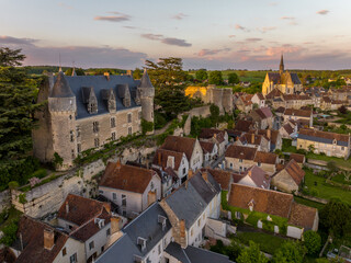 Aerial sunset view of Montresor medieval castle with a Renaissance mansion in Indre et Loire, on a rocky overhand dominating the valley, on of the most beautiful villages of France - obrazy, fototapety, plakaty