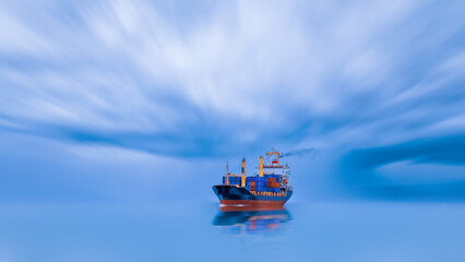 container cargo ship floating and reflecting as a shadow blur at the sea surface and torm...