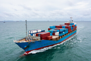container cargo ship sailing full speed in green sea to transport of goods import export...