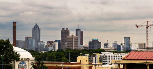 Midtown Atlanta  displaying several buildings, city streets, hotels and high rises under a blue sky.
