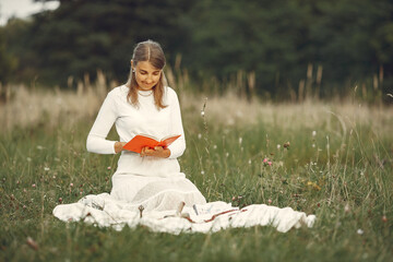 Young woman reading mantra on meadow alone