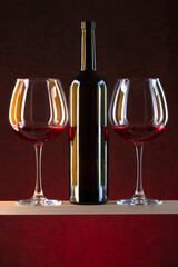 Still life with glasses of wine and a glass bottle