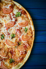 food cooking, culinary and people concept - cook or baker hand with pizza on peel at pizzeria