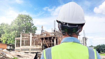 Fototapeta premium Behind the scenes of an engineer wearing a helmet at work. Portrait of an Asian engineer at a construction site