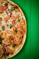 food cooking, culinary and people concept - cook or baker hand with pizza on peel at pizzeria