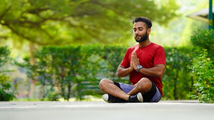 international yoga day image boy doing namaskaara in lotus position at park