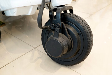 Close up of electric motor scooter front wheel.
