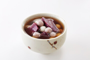 Delicious Chinese dessert, purple potato taro ball syrup .on white background