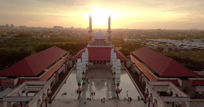 Aerial view of the great Mosque of Central Java (MAJT) in suset time. Th sun is orange and the weather is cloudy.