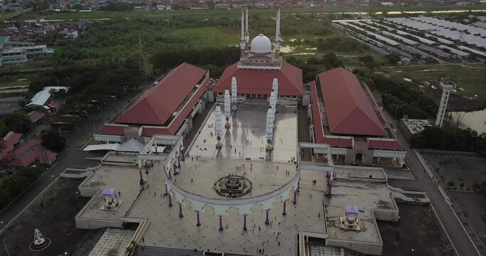 Aerial view of the great Mosque of Central Java (MAJT) in suset time. Th sun is orange and the weather is cloudy. Cyrcle drone shot