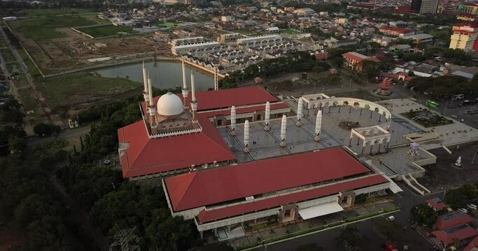 Aerial view of the great Mosque of Central Java (MAJT) in suset time. Th sun is orange and the weather is cloudy. Bird eye view