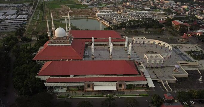 Aerial view of the great Mosque of Central Java (MAJT) in suset time. Th sun is orange and the weather is cloudy. Side view of the mosque