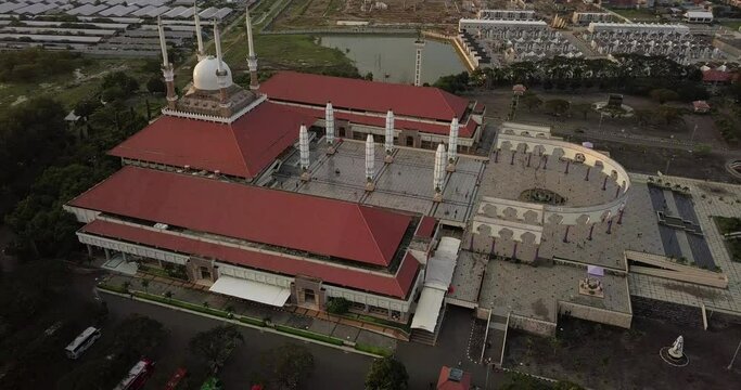 Aerial view of the great Mosque of Central Java (MAJT) in suset time. Th sun is orange and the weather is cloudy. View from the side