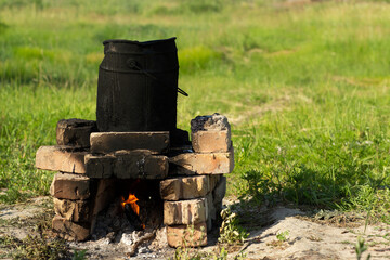 heating tar on a fire
