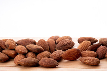 almond seeds on wooden table background, healthy food
