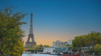The landmark view  as Romantic scene in Autumn  season with Eiffel Tower and boats on Seine river in Paris, France.