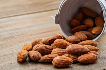 almond seeds on wooden table background, healthy food
