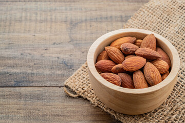 almond seeds on wooden table background, healthy food
