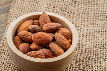 almond seeds on wooden table background, healthy food
