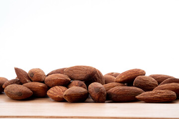 almond seeds on wooden table background, healthy food
