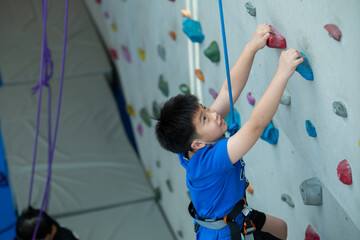 kid climbing a wall, children rock climbing
