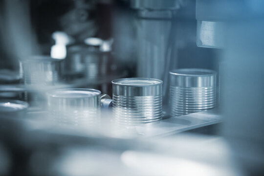 Aluminum Cans moving on aluminum can production line in a factory. Aluminum, metal, container can transfer on conveyor belt. Industrial technology for metal, can and container factory.