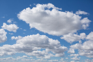 Naklejka na ściany i meble many large and small white clouds, against the blue sky