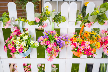 colorful artificial plastic flower in flower Pots Hanging with fence