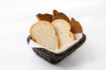 White and black sliced bread on a plate on a white background