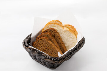 White and black sliced bread on a plate on a white background