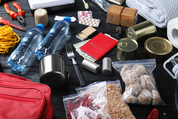 Disaster supply kit for earthquake on black wooden table