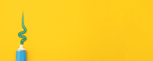 Tube with squeezed out toothpaste on yellow background, top view with space for text. Banner design - obrazy, fototapety, plakaty
